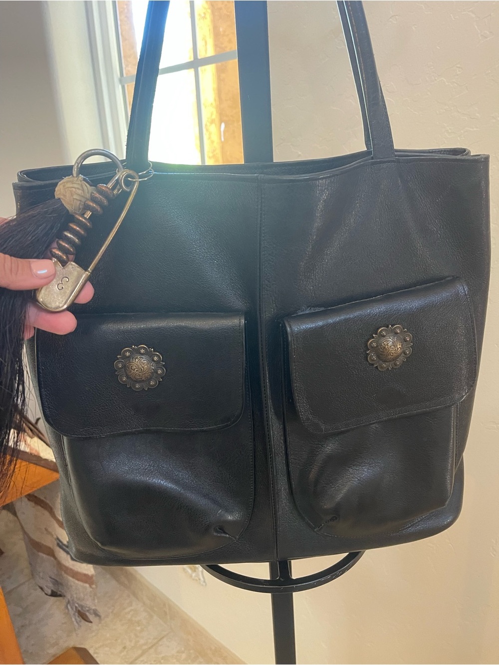 Black Leather Tote with Front Pockets and Tassel Charm